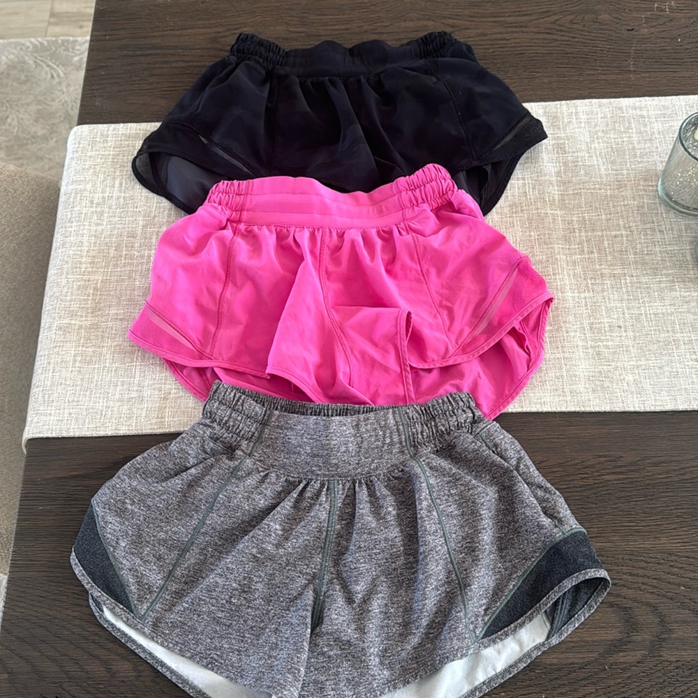 Three pairs of 2.5 size 2 lululemon hotty hots. Heather grey, camo, sonic pink